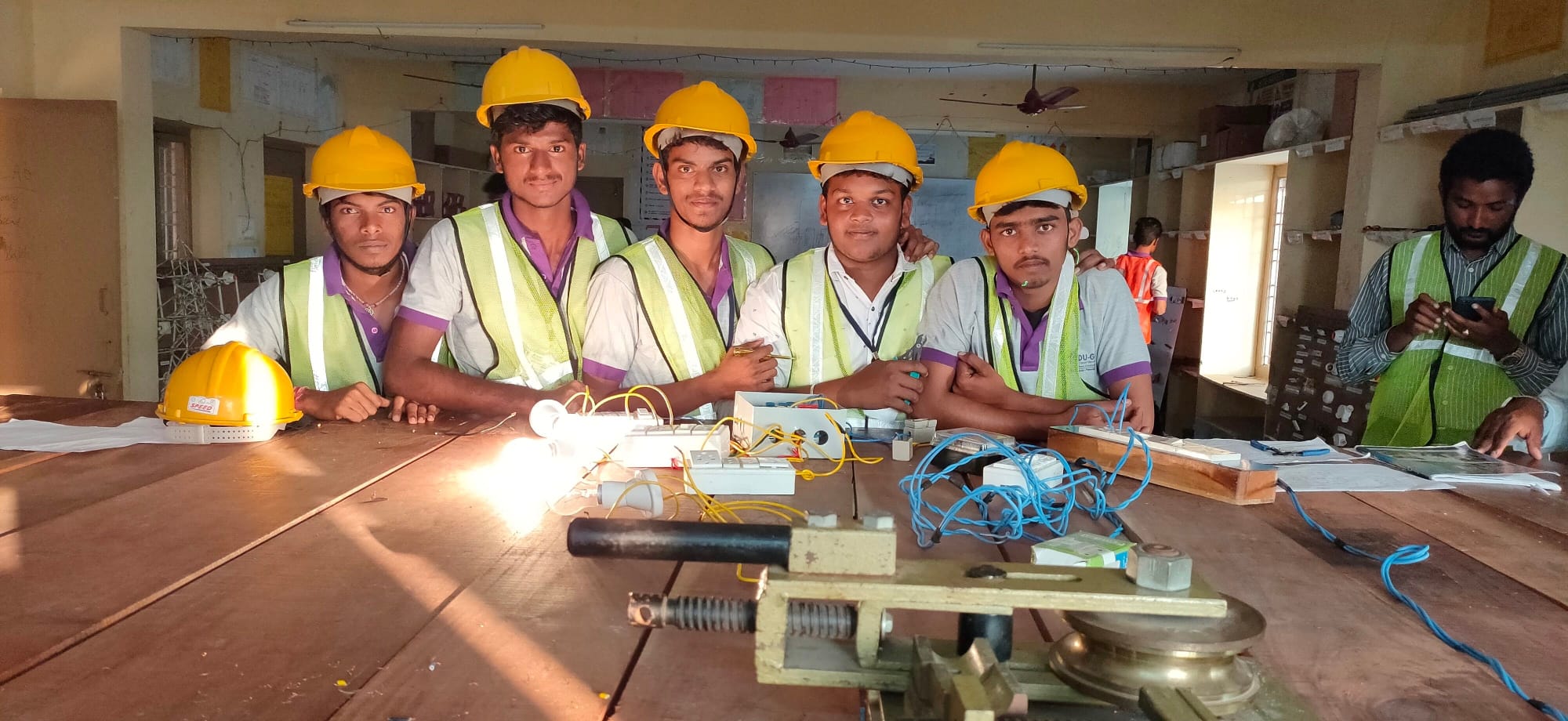 Student team with electrical wiring and circuit demonstration equipment