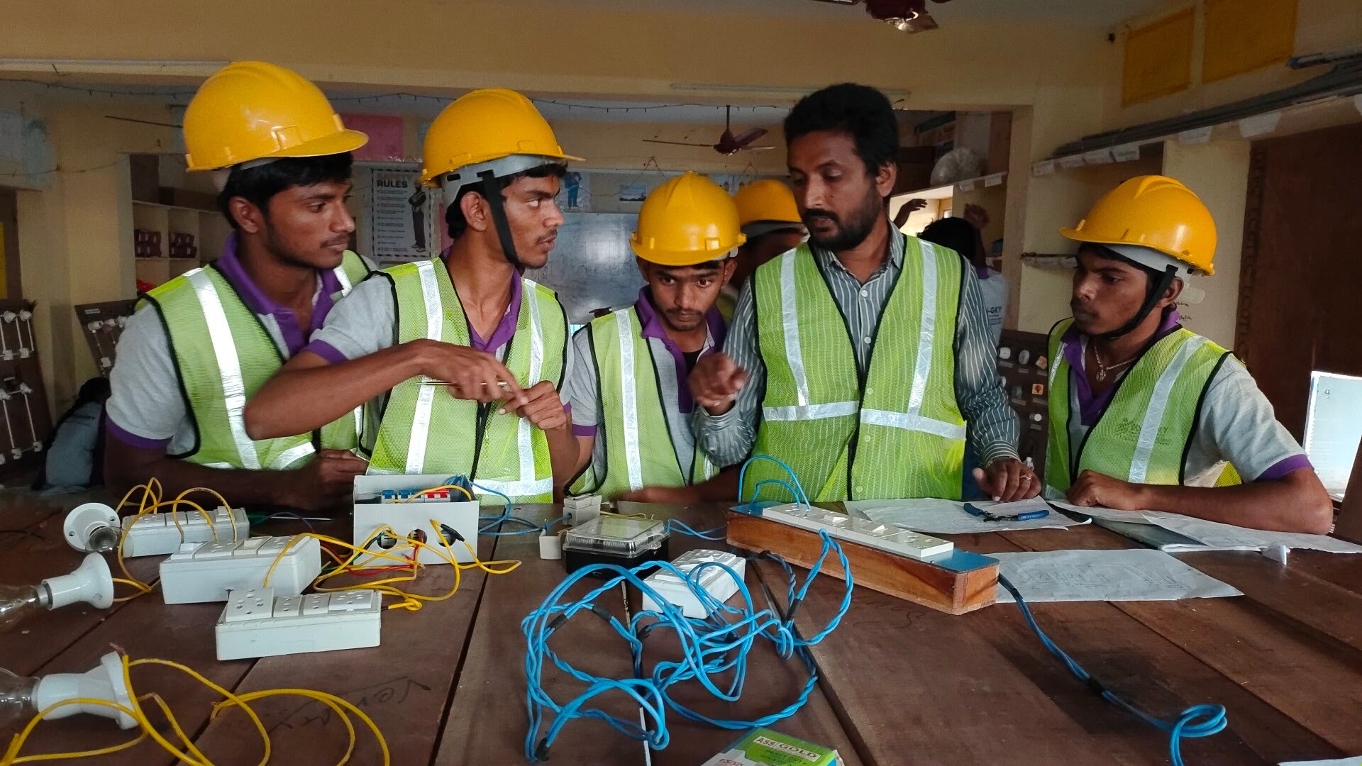 Diploma students working with an instructor during the 24-hour electrical and electronics workshop
