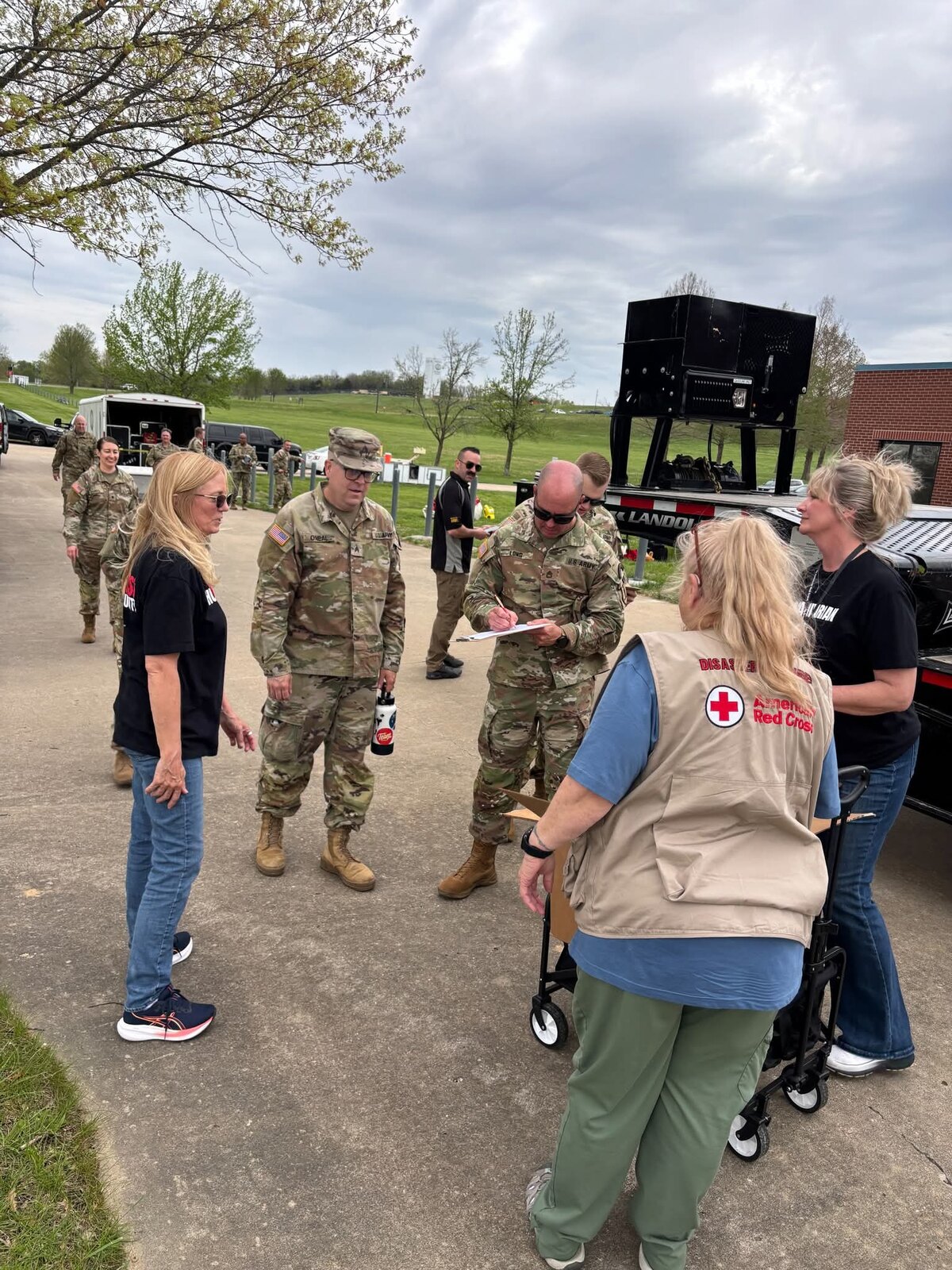 American Red Cross volunteers coordinating with partner personnel during a field activity